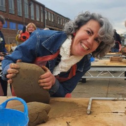 Photo of Abi running a clay sculpture workshop