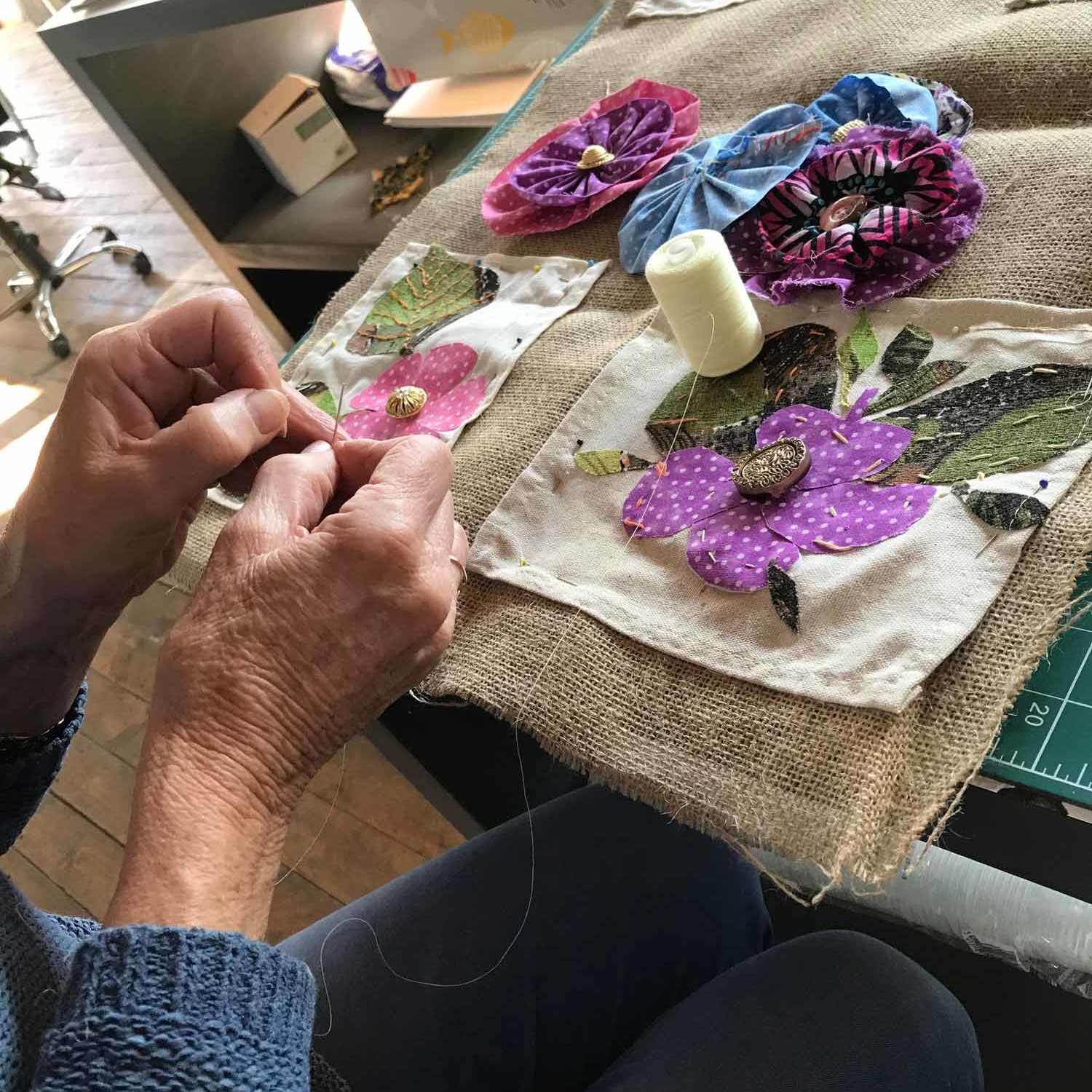 slow stitching embellishments to the leaves and petals